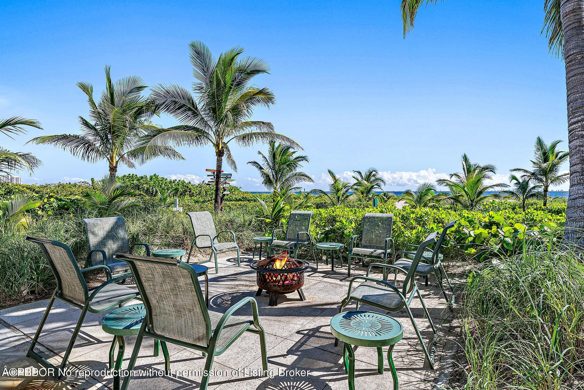 111 Reef Road Palm Beach, FL 33480 - Photo 23 of 28 a view of a chairs and table in a backyard