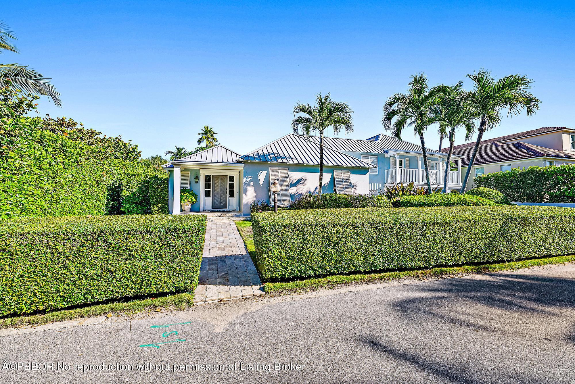 111 Reef Road Palm Beach, FL 33480 - Photo 3 of 28 a front view of a house with a garden