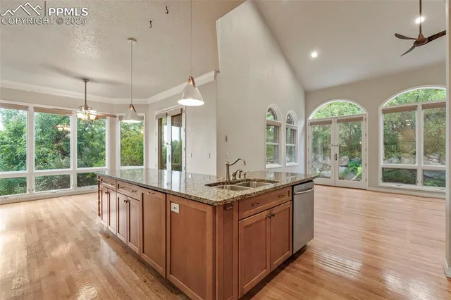 a kitchen with stainless steel appliances granite countertop a stove and a large window