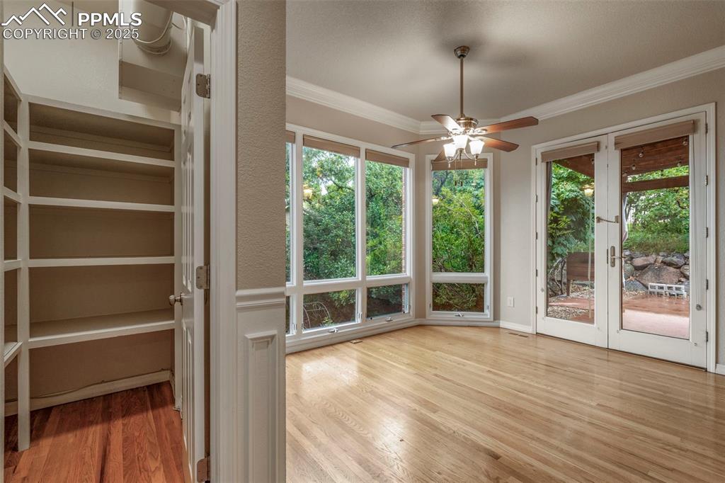 4930 Langdale Way Colorado Springs, CO 80906 - Photo 16 of 49 a view of an empty room with wooden floor and a window