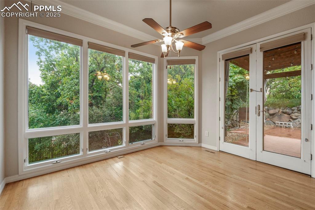 4930 Langdale Way Colorado Springs, CO 80906 - Photo 17 of 49 a view of an empty room with wooden floor and a window