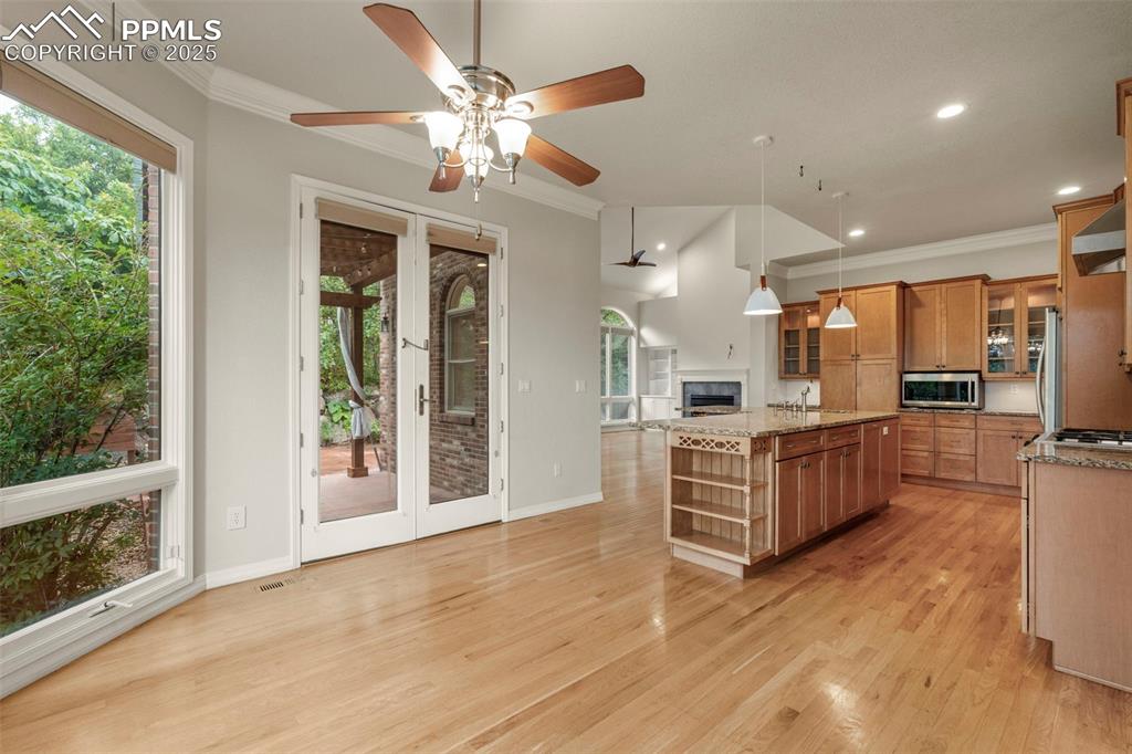 4930 Langdale Way Colorado Springs, CO 80906 - Photo 18 of 49 a large kitchen with stainless steel appliances granite countertop a large oven a stove oven and a refrigerator with wooden floor