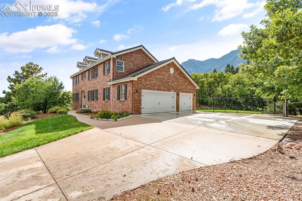 4930 Langdale Way Colorado Springs, CO 80906 - Photo 2 of 49 a front view of a house with a yard and trees