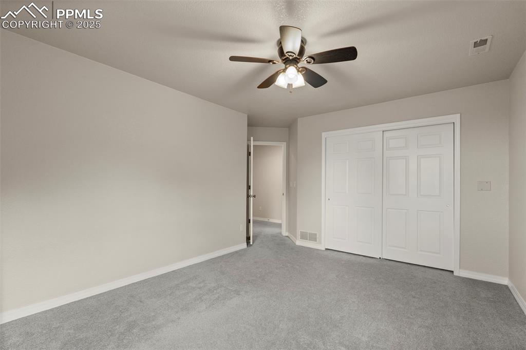 4930 Langdale Way Colorado Springs, CO 80906 - Photo 33 of 49 a view of an empty room and chandelier fan