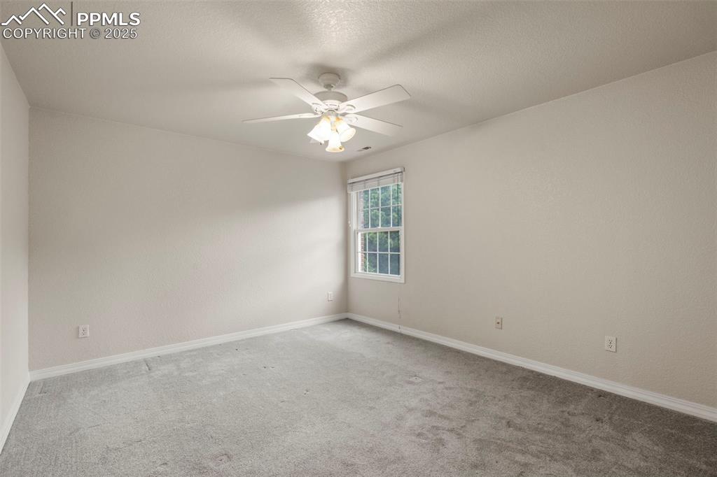 4930 Langdale Way Colorado Springs, CO 80906 - Photo 34 of 49 an empty room with a window and a fan