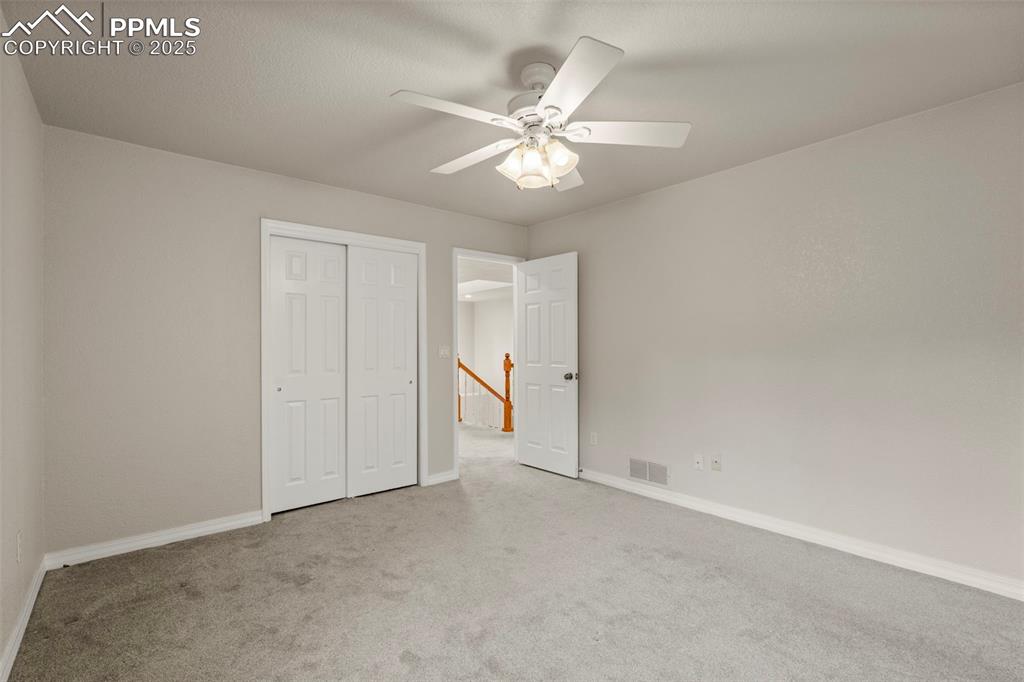 4930 Langdale Way Colorado Springs, CO 80906 - Photo 35 of 49 a view of an empty room and chandelier fan