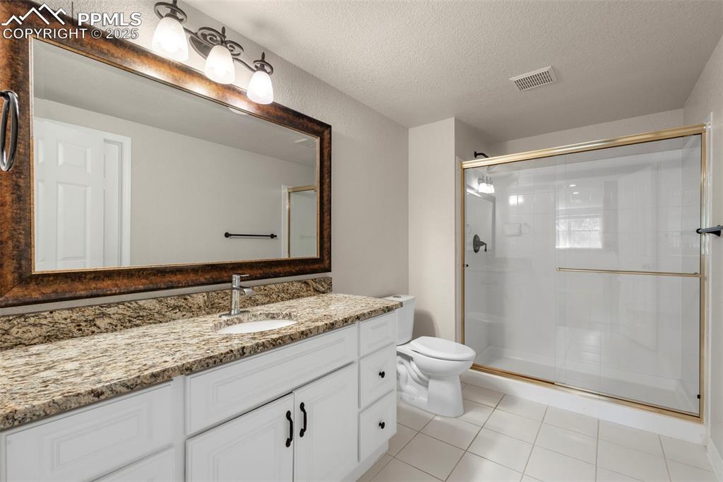 4930 Langdale Way Colorado Springs, CO 80906 - Photo 45 of 49 a bathroom with a granite countertop sink mirror and toilet