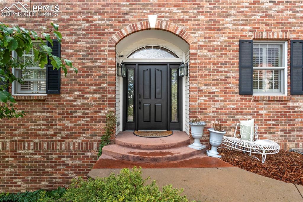 4930 Langdale Way Colorado Springs, CO 80906 - Photo 5 of 49 a front view of a house with a garden