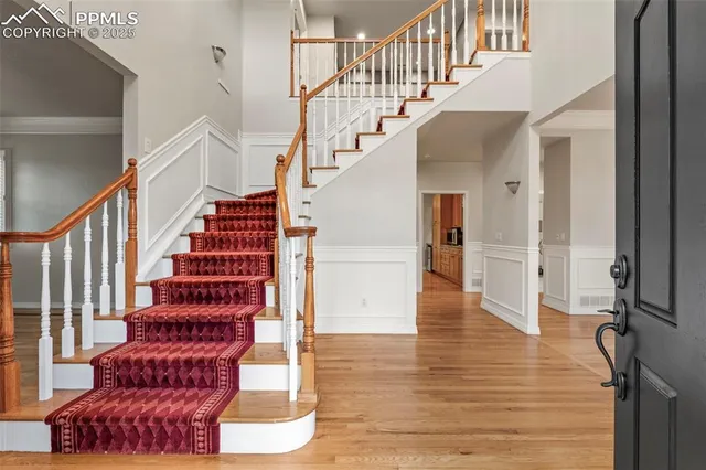 a view of entryway and hall with wooden floor