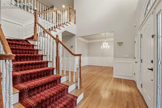 a view of entryway with wooden floor and stairs