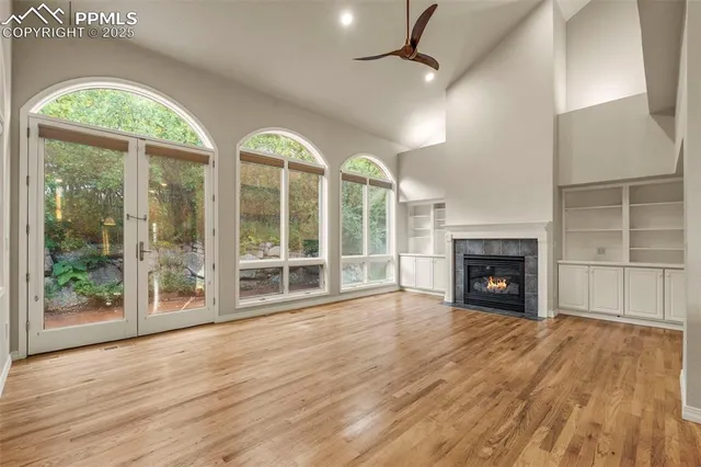 a view of an empty room with a fireplace and a window