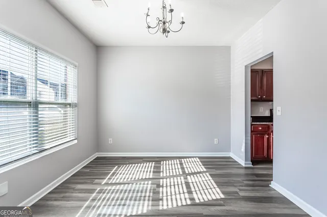 a view of wooden floor and windows in a room