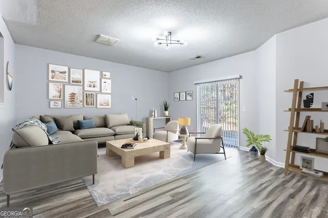 a living room with furniture and a bookshelf