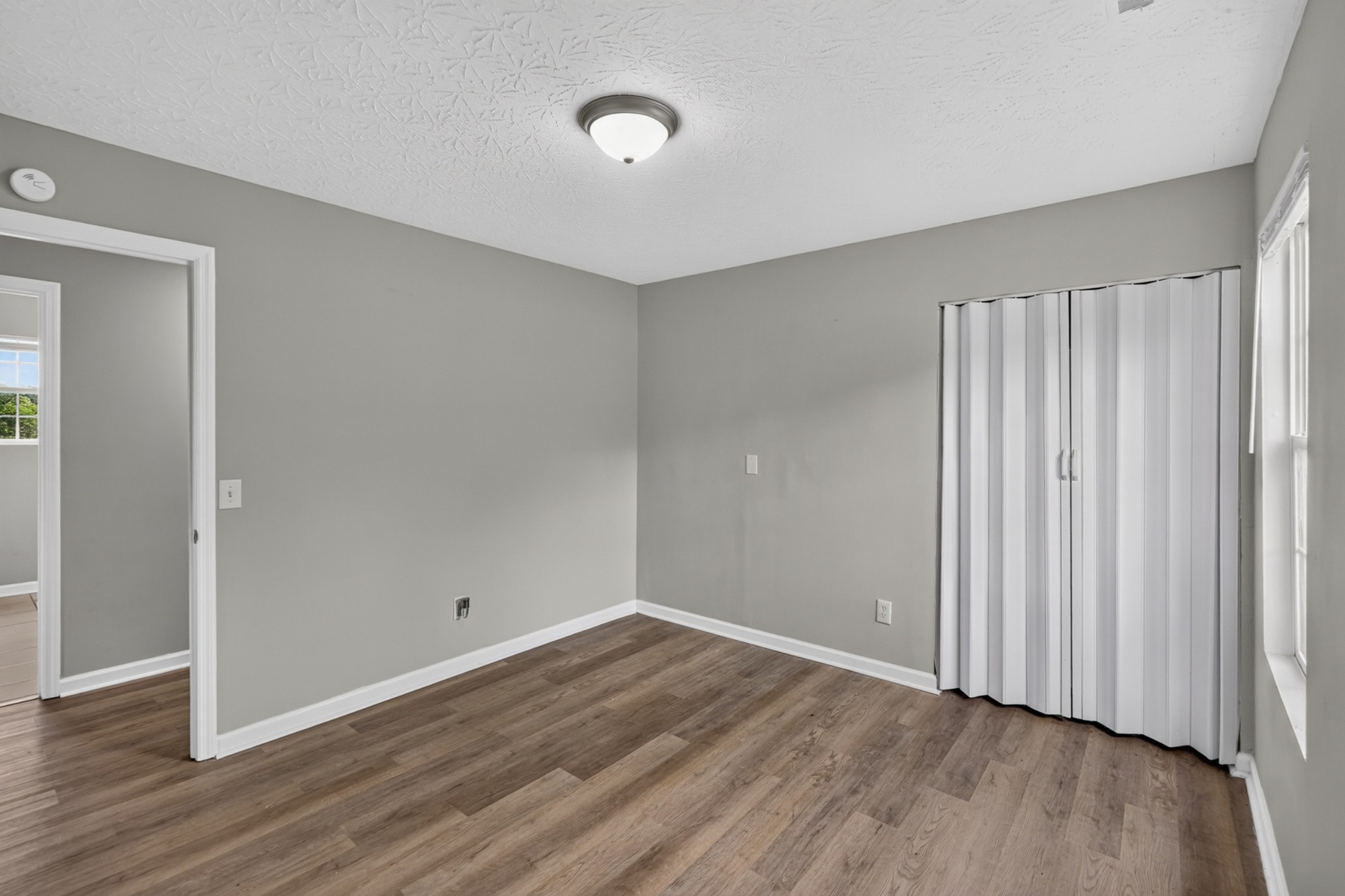 120 Driver Road Lafayette, TN 37083 - Photo 21 of 39 an empty room with wooden floor and windows
