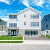 a front view of a house with a garden and plants