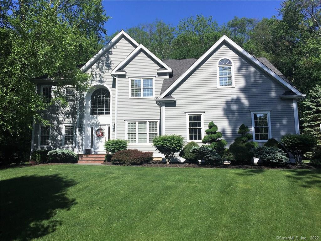 22 Beech Tree Hill Road Shelton, CT 06484 - Photo 1 of 1 a front view of a house with a garden and plants