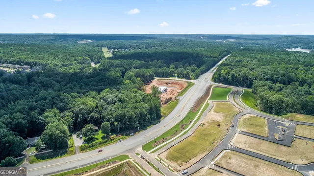an aerial view of a house with a garden and swimming pool
