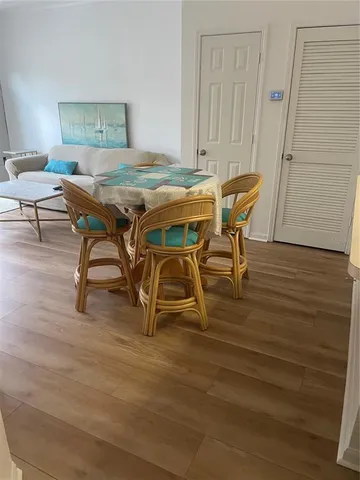 a dining room with furniture and wooden floor