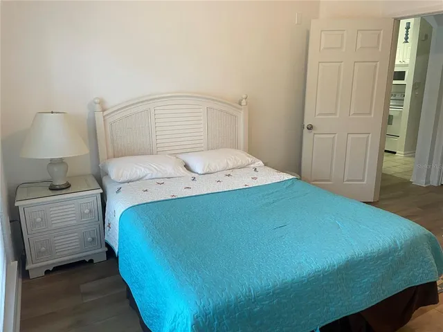 a bedroom with a bed and a lamp