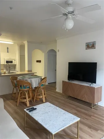 a living room with a table chairs and a flat screen tv
