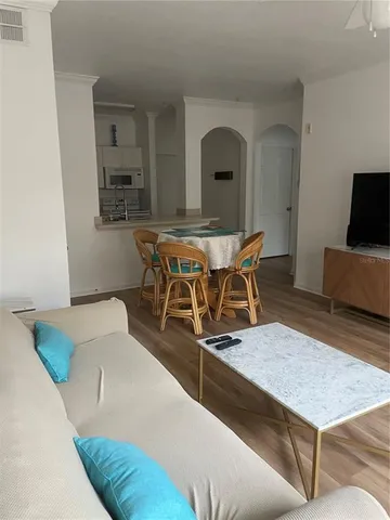 a living room with chairs and a table