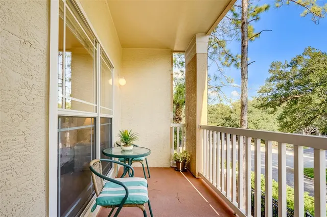 a balcony with table and chairs
