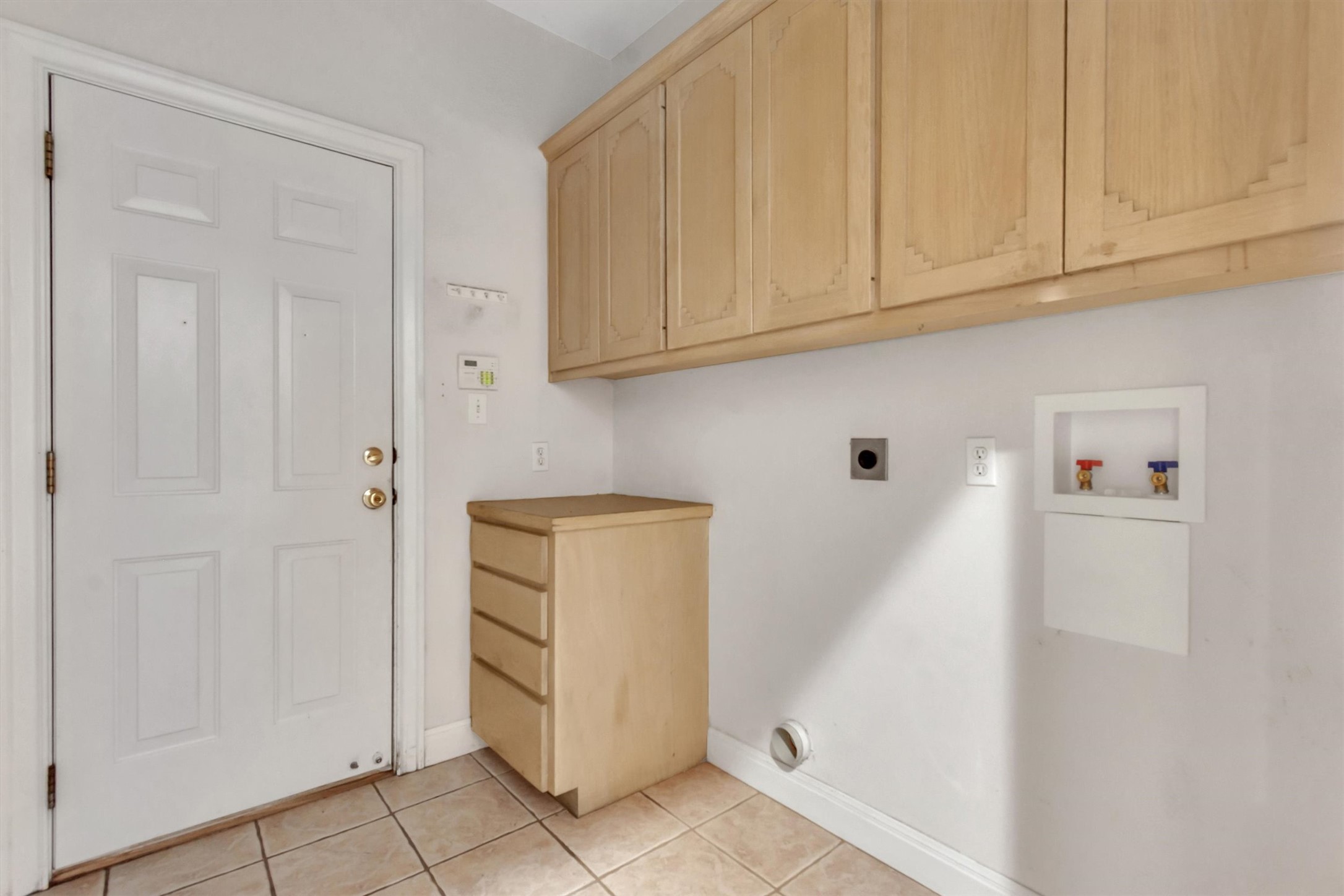 1120 Meadow Ridge Drive Austin, TX 78737 - Photo 26 of 40 Functional laundry area featuring ample cabinet storage and easy access.