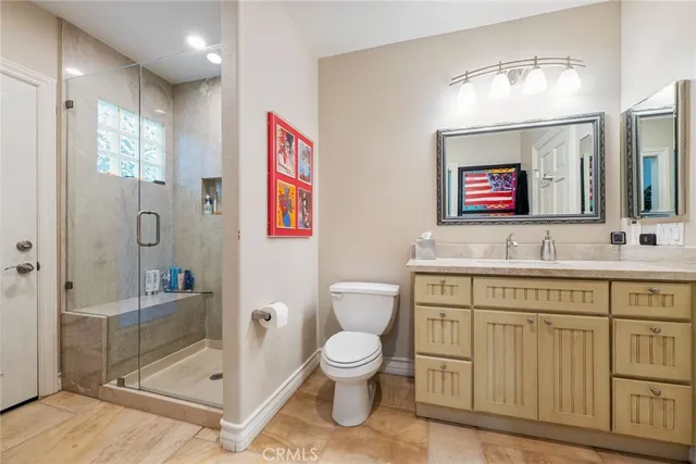 a spacious bathroom with a toilet a sink and shower
