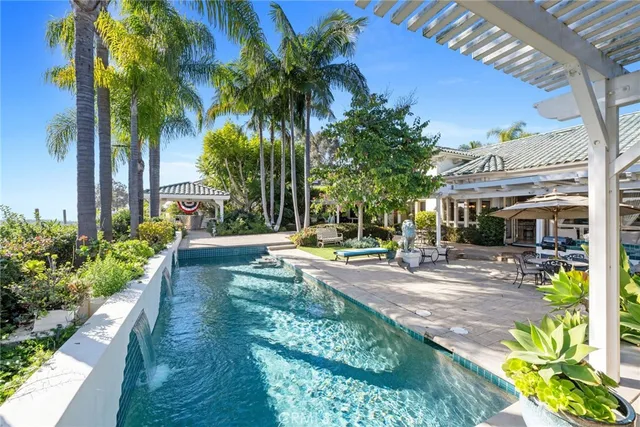a view of a backyard with plants and swimming pool