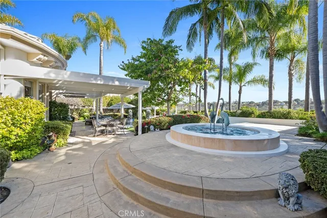a view of a house with a yard and palm trees