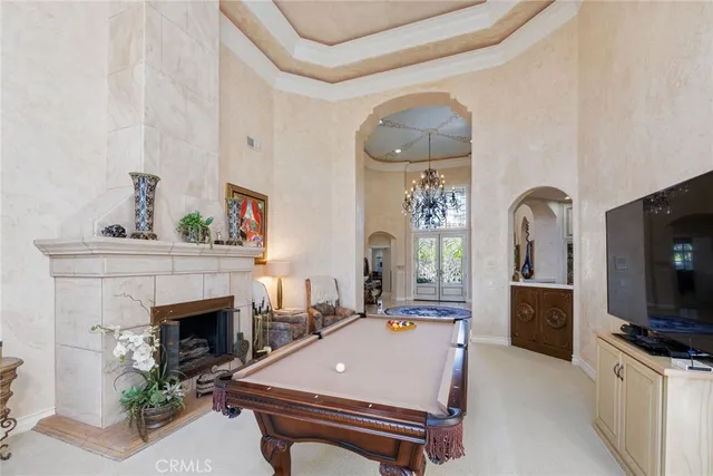 a living room with furniture a fireplace and flat screen tv