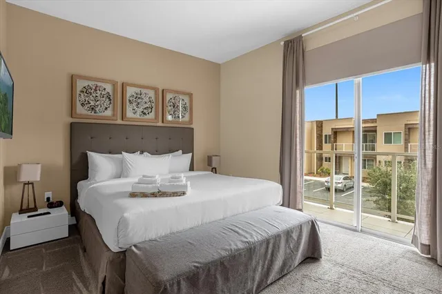 a bed sitting in a bedroom next to a window