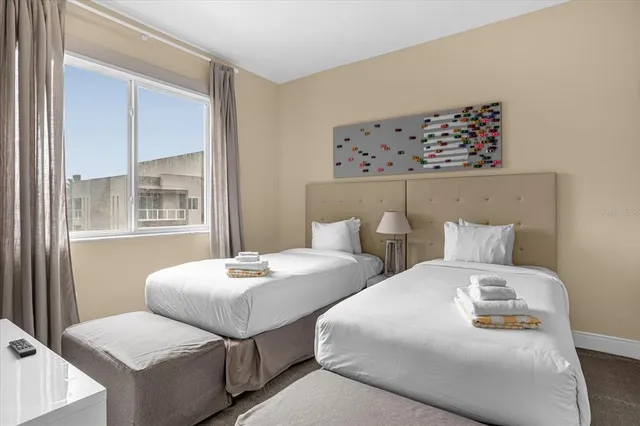 a bedroom with two beds and a window