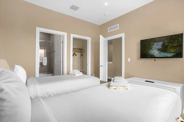 a bedroom with a bed and a flat screen tv