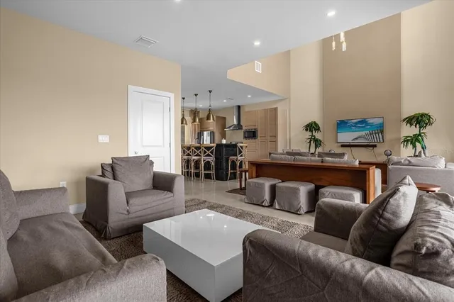 a living room with furniture and kitchen view