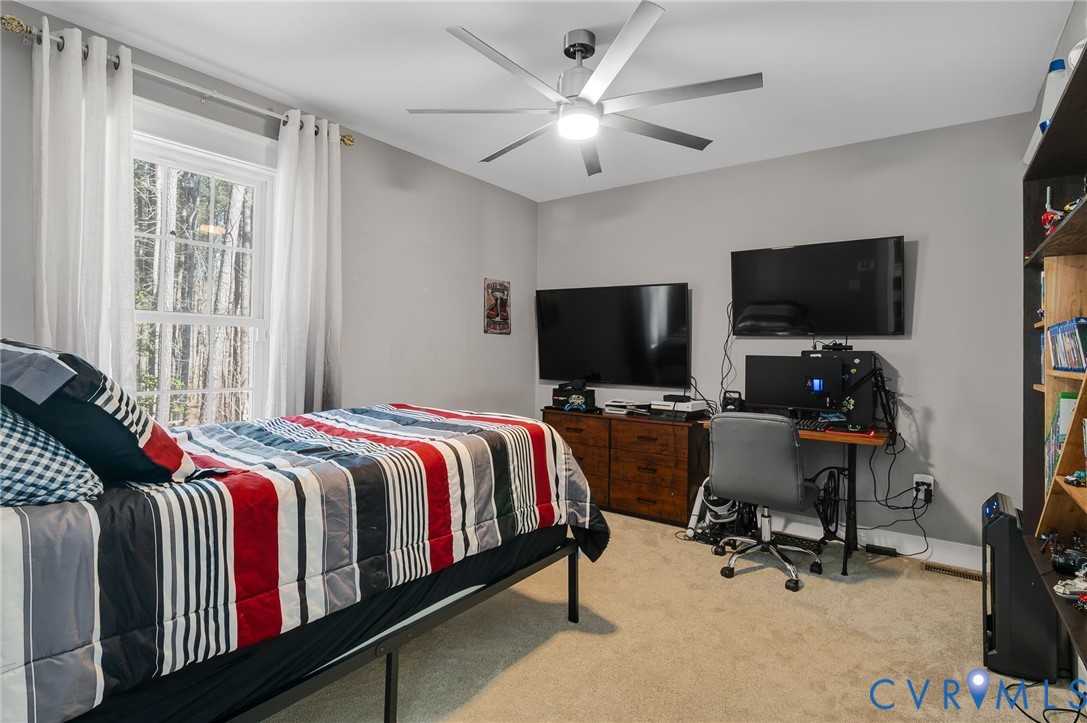 15330 Wilkinson Road Dinwiddie, VA 23841 - Photo 21 of 43 a bedroom with a bed and a flat screen tv