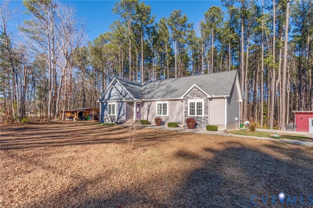 15330 Wilkinson Road Dinwiddie, VA 23841 - Photo 42 of 43 a view of a town with large trees and fence