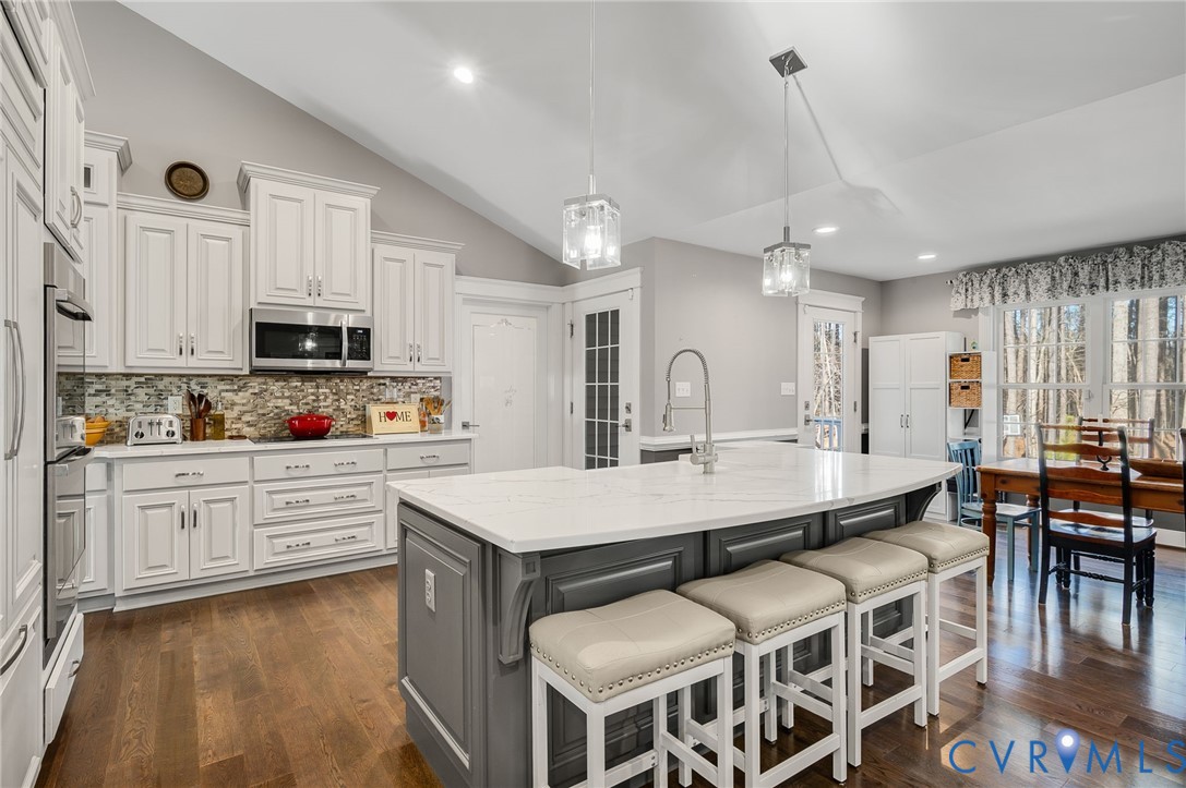 15330 Wilkinson Road Dinwiddie, VA 23841 - Photo 8 of 43 a large kitchen with kitchen island a sink table and chairs