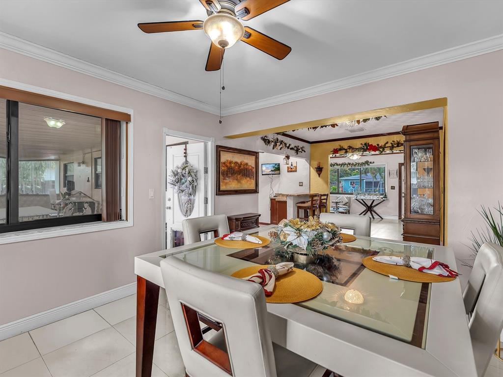 6631 Southwest 24th Street Miramar, FL 33023 - Photo 11 of 42 a view of a dining room with furniture and a chandelier fan