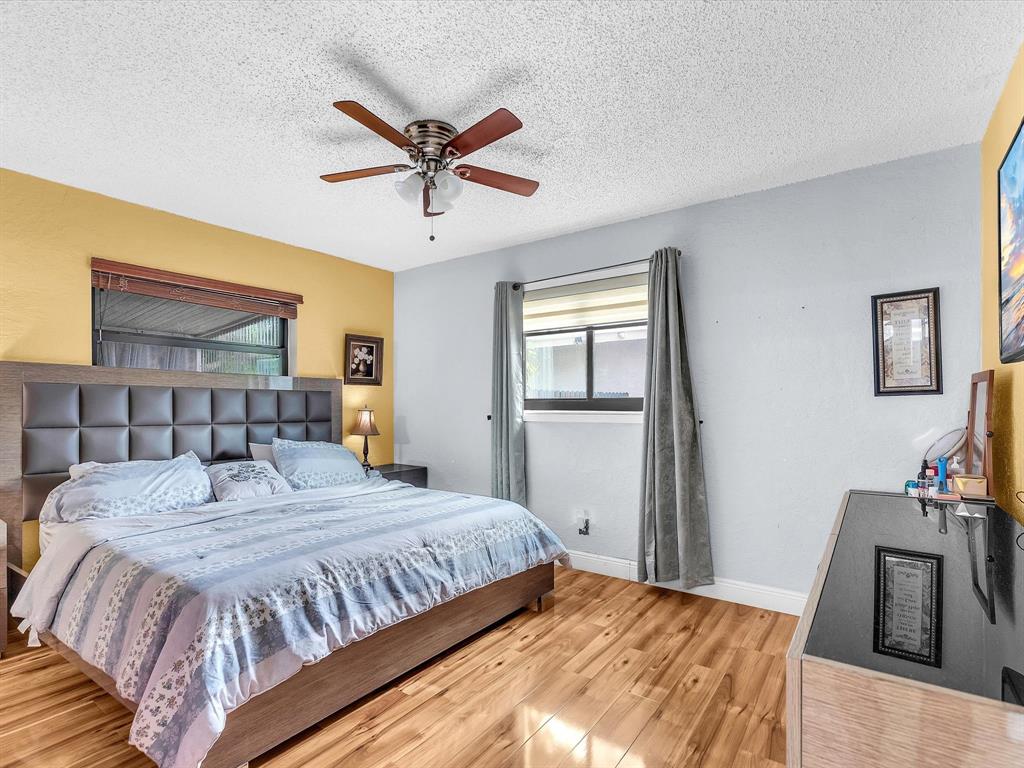 6631 Southwest 24th Street Miramar, FL 33023 - Photo 17 of 42 a bedroom with a bed and a mirror on a dresser