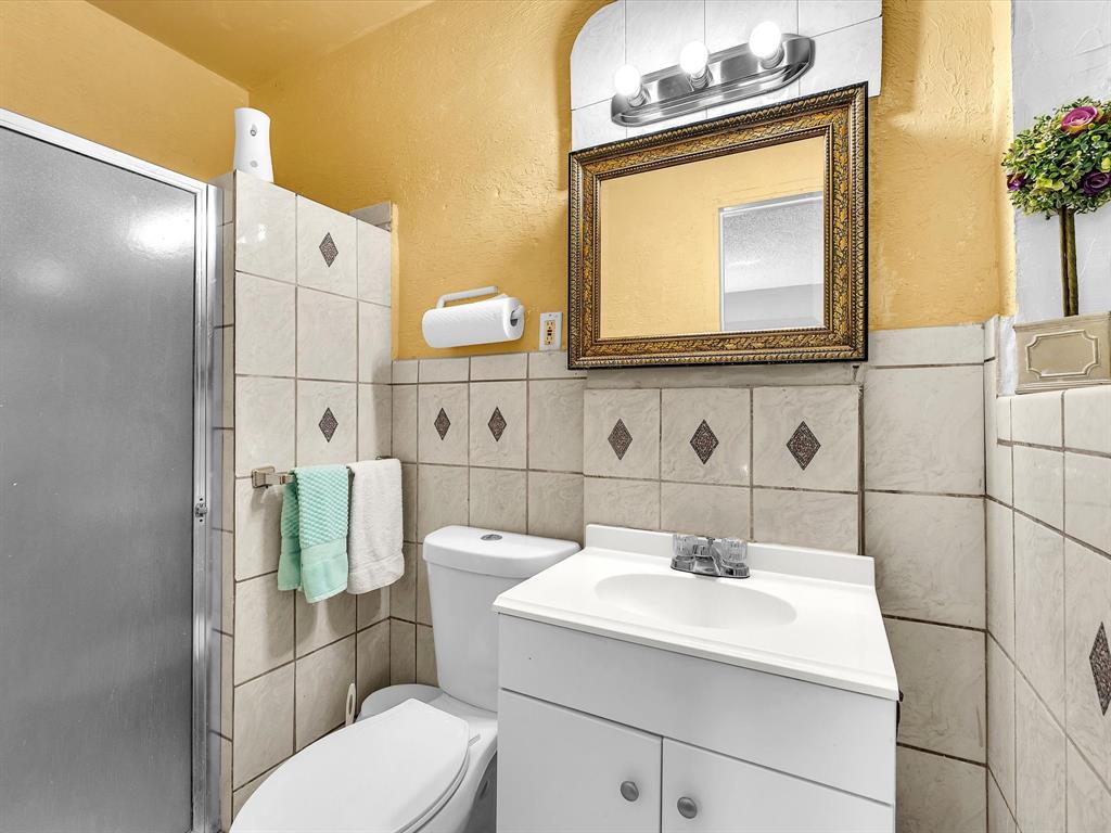 6631 Southwest 24th Street Miramar, FL 33023 - Photo 19 of 42 a bathroom with a sink a toilet and mirror