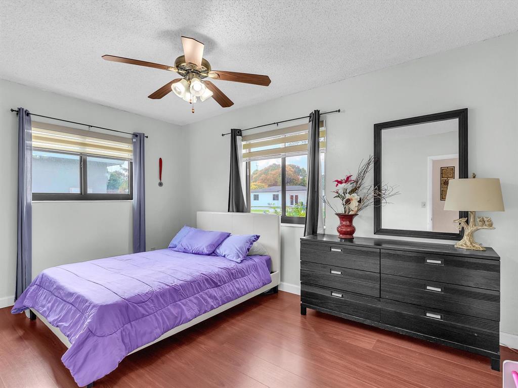 6631 Southwest 24th Street Miramar, FL 33023 - Photo 20 of 42 a bedroom with a bed and wooden floor