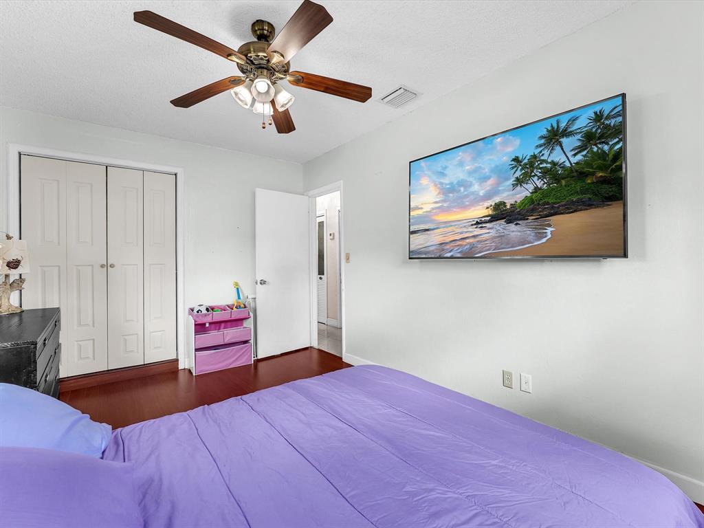 6631 Southwest 24th Street Miramar, FL 33023 - Photo 21 of 42 a bedroom with a bed and a chandelier