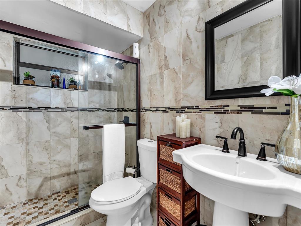 6631 Southwest 24th Street Miramar, FL 33023 - Photo 22 of 42 a bathroom with a sink a toilet and a mirror