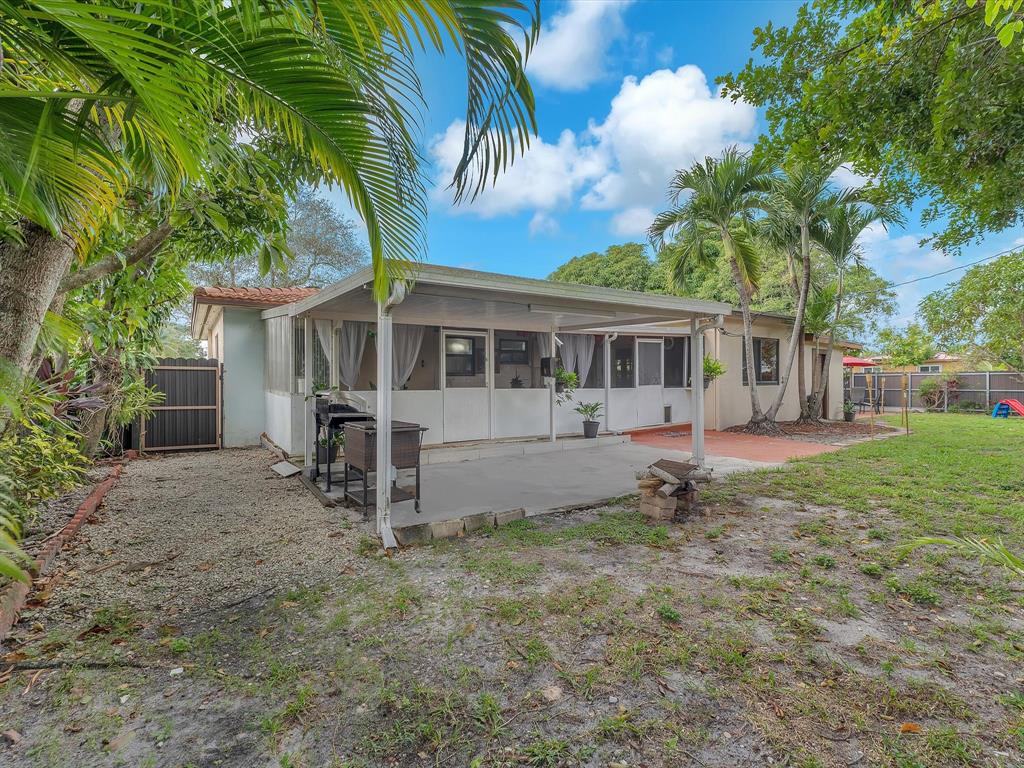 6631 Southwest 24th Street Miramar, FL 33023 - Photo 28 of 42 a view of a house with a yard and potted plants