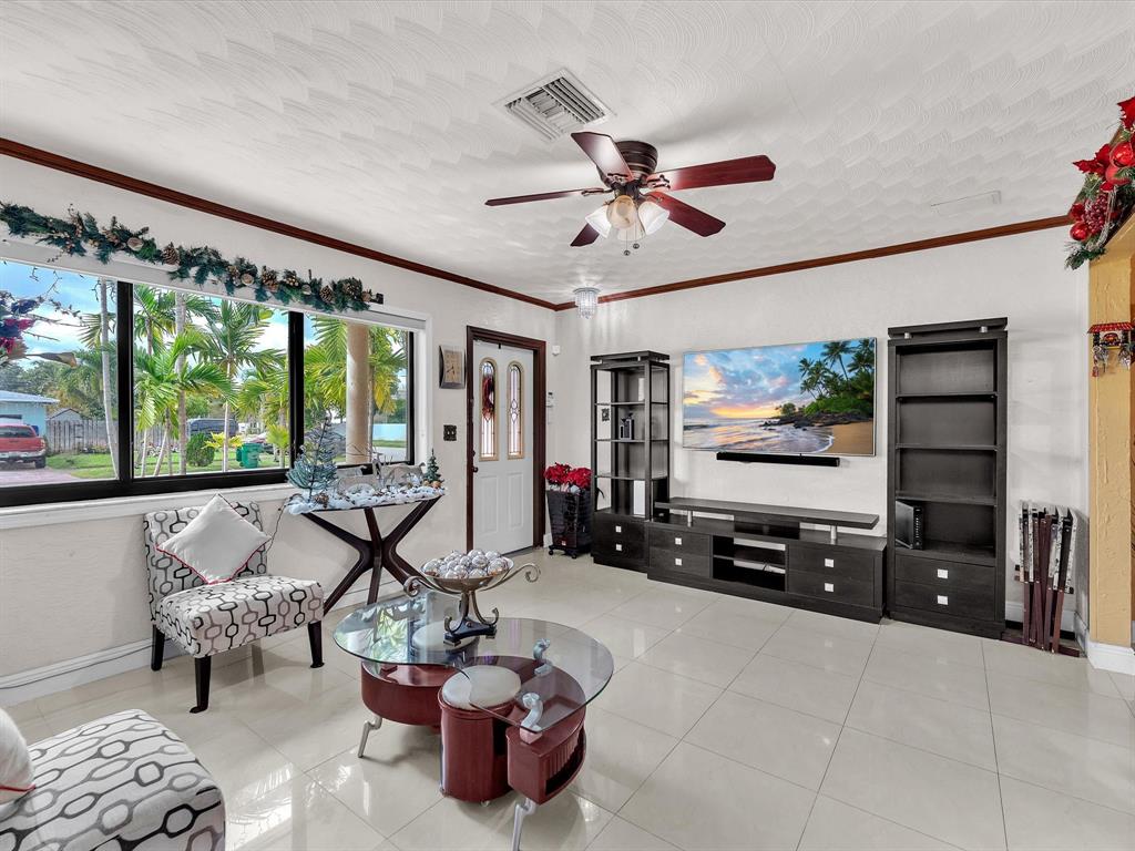 6631 Southwest 24th Street Miramar, FL 33023 - Photo 8 of 42 a living room with furniture and a flat screen tv