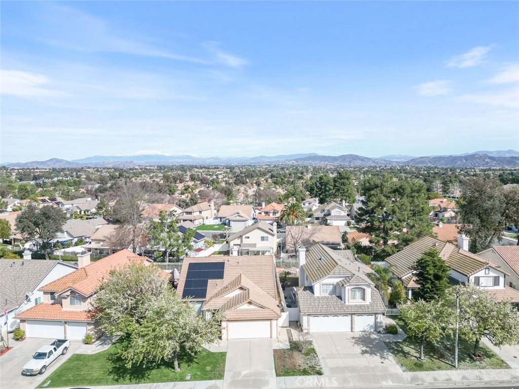 an aerial view of residential houses with city view