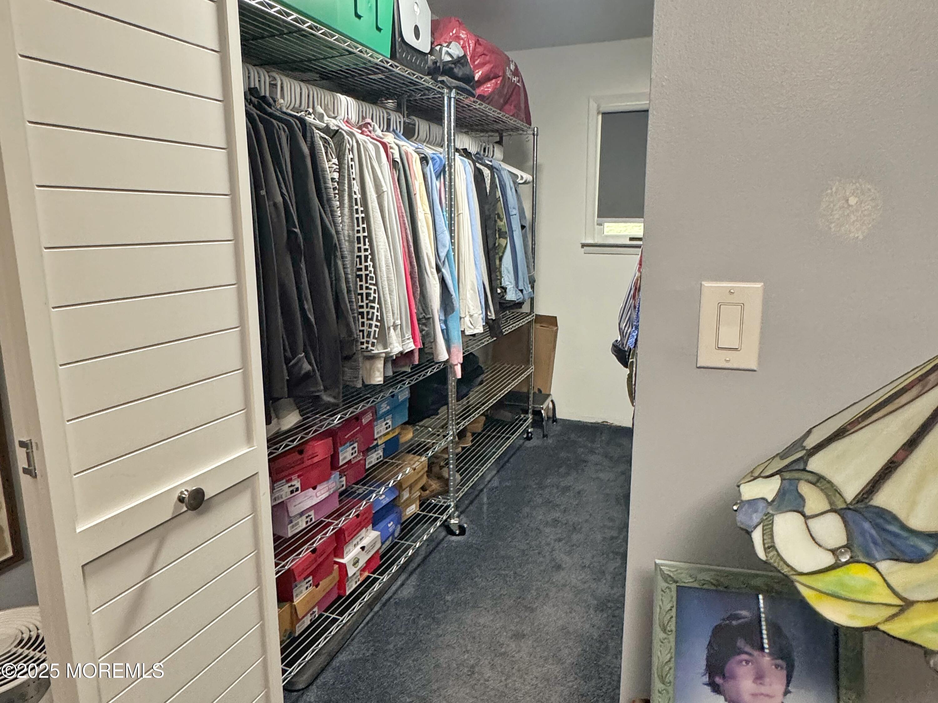 39 Boxwood Terrace Red Bank, NJ 07701 - Photo 17 of 25 a view of walk in closet with clothes and shoes