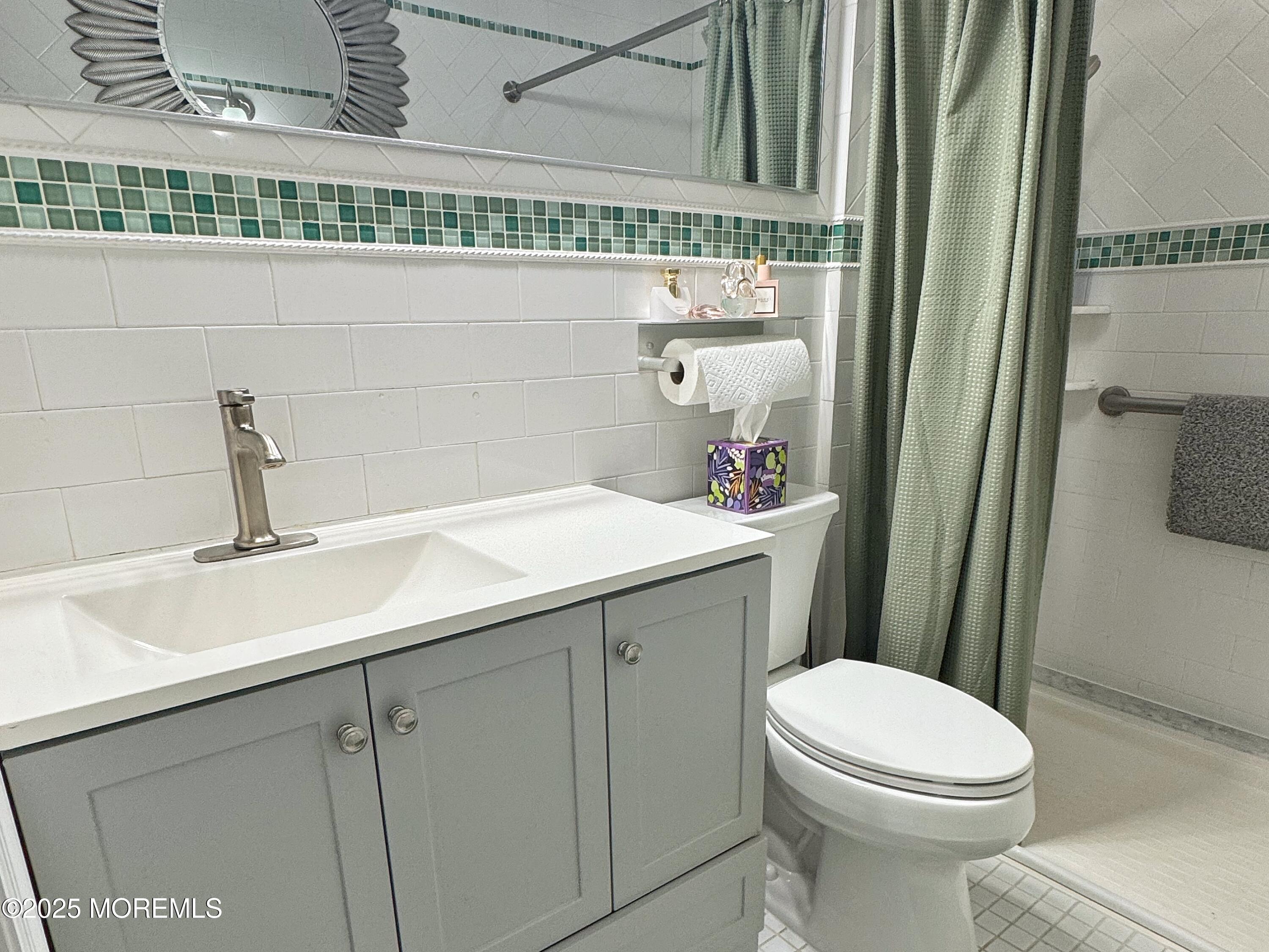 39 Boxwood Terrace Red Bank, NJ 07701 - Photo 18 of 25 a bathroom with a sink a toilet and mirror
