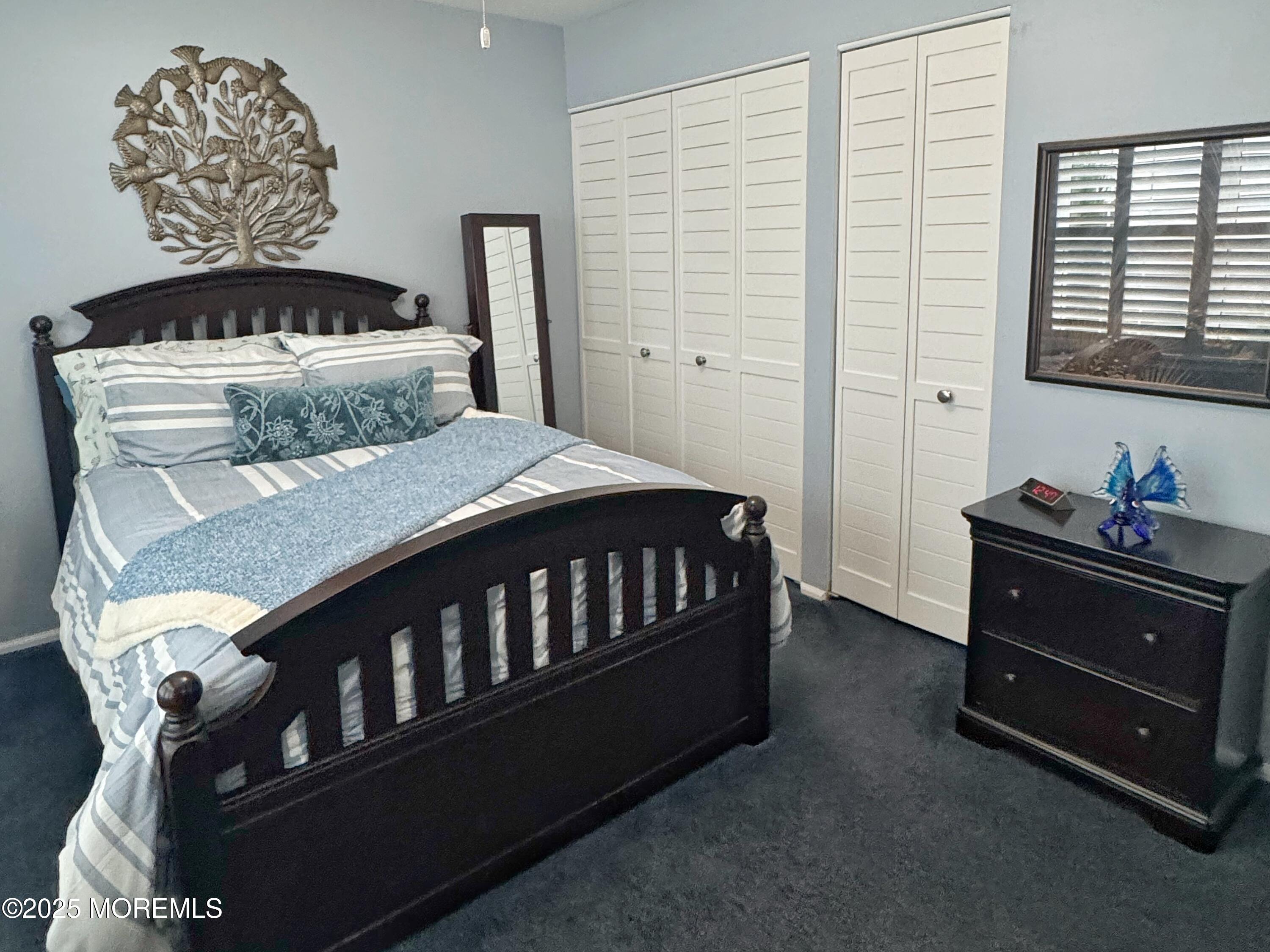 39 Boxwood Terrace Red Bank, NJ 07701 - Photo 20 of 25 a bedroom with a bed and a table in it